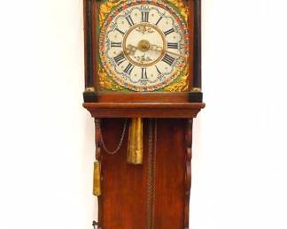 A 19th century Dutch "Staartklok" wall clock. 30-hr weight driven time, strike and alarm movement with painted metal dial and Roman numerals, Maritime scene with Ships at sea in the arch, embossed Brass bezel and lower spandrels. Oak case with an arched hood and painted Pewter figural finials over an arched door with Ebonized pilasters and Brass capitols, traditional "fishtail" drop slides open to access pendulum. Older refinishing with minor damage and some wear, running when cataloged. Older finish with some wear and minor damage, running when cataloged. 56 1/4" high overall.