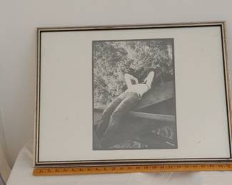 Signed black and white photograph of a photographer lying across a steel girder bridge, circa 1977