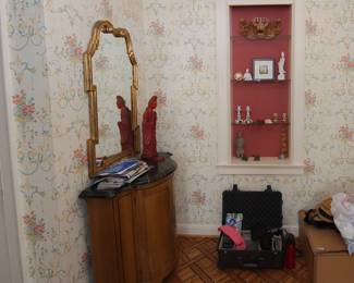 Marble-topped curved front side table cabinet; statues of bodhisattva Guanyin (also known as Avalokiteśvara), a hardshell carrying case/luggage with padded insides for video or music gear
