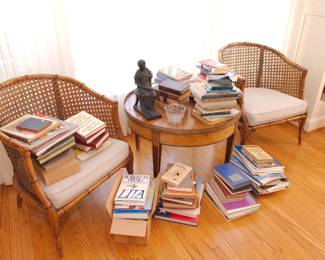 A Louis XVI style side table with pierced brass gallery, a pair of faux bamboo rattan cane barrel back armchairs, lots of books!