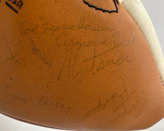 Closeup of 1977 Notre Dame Team Signed Football - includes signatures from Coach Dan Devine, players including Joe Montana, Bob Golic, Vagas Ferguson, Rusty Lisch, Dave Wagmer, Kris Haines and many more. Appears to hold +50 signatures.