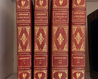 Leather bound hardcovers of Carl Sandburg's series on Abraham Lincoln: The Prairie Years volumes I and II, and The War Years volumes III and IV