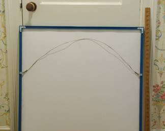 Reverse of framed artwork of two sailboats