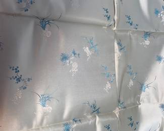 LOT 54: An Asian blue with light design silk fabric. 70 x 29 inches.