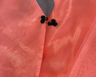 Lot 44: A Set of Korean Ladies Jacket and Skirt. Orange jacket with gray v-neck trip and black closures. Gray pleated skirt to match jacket trim. Jacket: Length: 22.5 x Waist: 18.5 x Underarms: 19
inches Skirt: Waist 18 x Length 33 x Hips 52 inches
In good condition.
