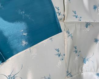 LOT 54: An Asian blue with light design silk fabric. 70 x 29 inches.