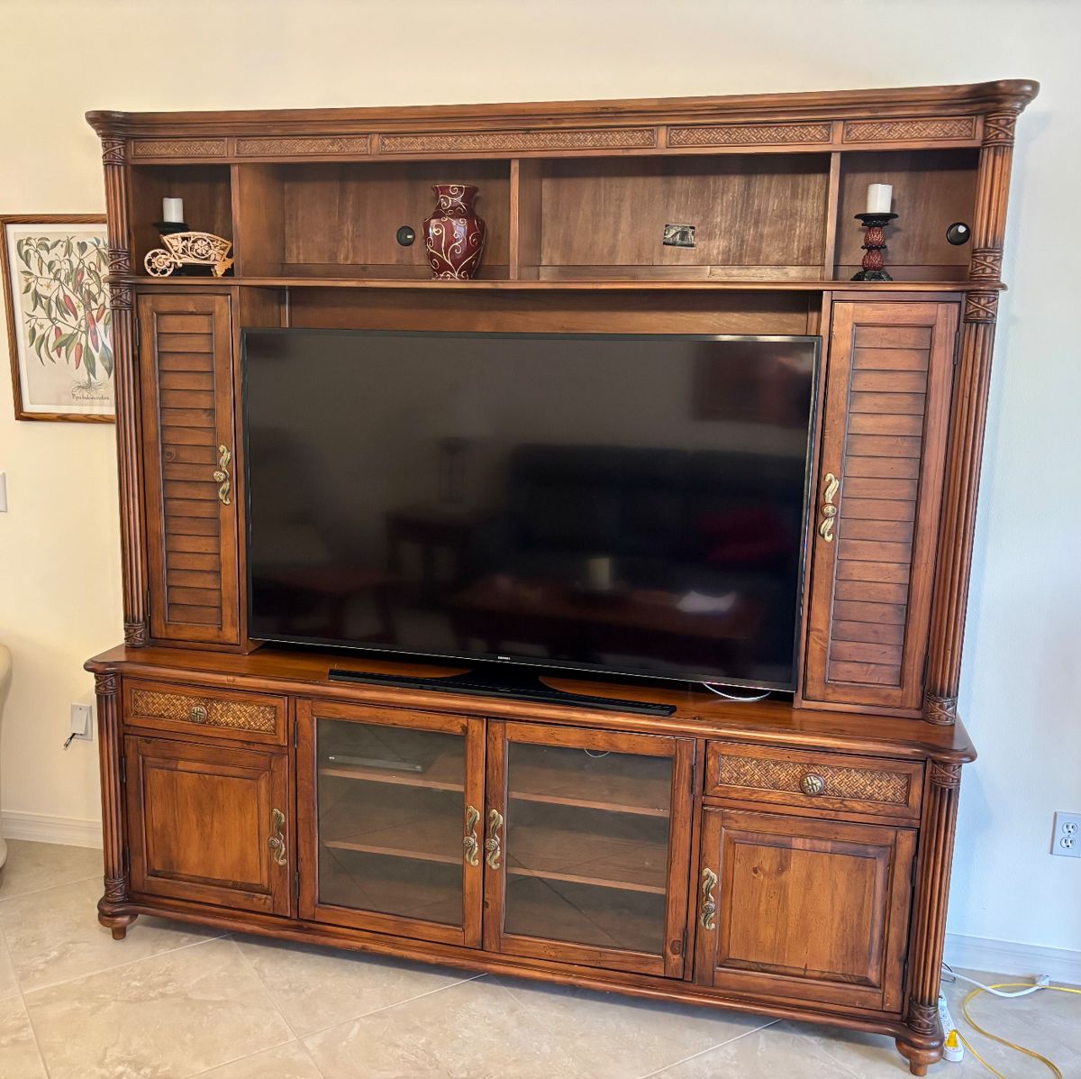 Samsung UHD TV. Use the cabinet to hide the good liquor as needed.