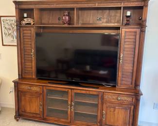 Samsung UHD TV. Use the cabinet to hide the good liquor as needed.