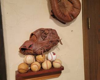 Vintage baseball gloves and balls.