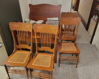 Gorgeous antique wooden dining table with four caned wood carved chairs. 
