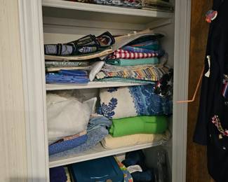 lots of table clothes, place mats, napkins and more