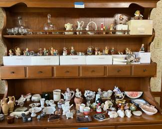 Middle Shelf has Studio Hummel Christmas ornaments made by Bertie Hummel (Sets 1-8 and Set 28--each set has 3 ornament figures each with certificate of authenticity). Top shelf additional Hummels, and decanter sets. Bottom table top are various figurines.