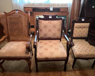Two antique chairs in the middle and right and third chair on left