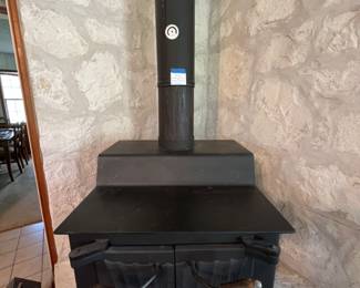 Calistoga wood stove with metal smokestack piping
