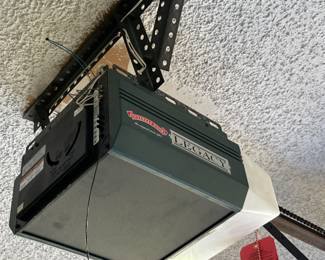 Two Legacy garage door openers with remotes