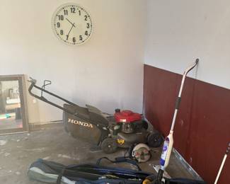 Lawn mower. Skis and ski boots.
