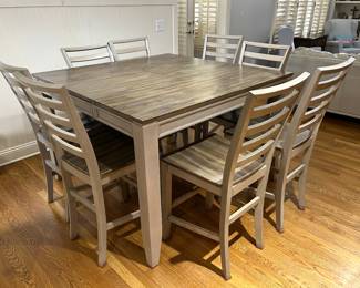 pub table and 8 chairs. leaf stores under the table