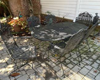 wrought iron mesh table and 2 spring chairs and 4 stationary chairs
