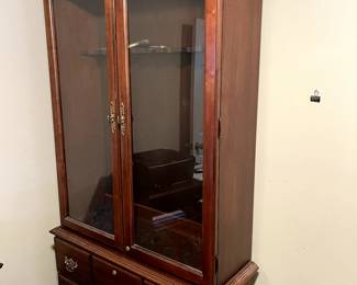 Beautiful Cherry Gun Safe with glass doors.Unusual piece, but so good looking!  This is for the gun collector who likes to show off his treasures!  Yes, it locks!  Storage drawers at bottom...great piece!