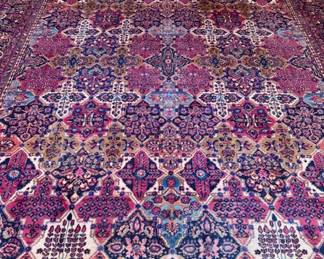 $700; wool knotted rug with deep violet hues with navy; fringe on two ends; approx 9'x11'
