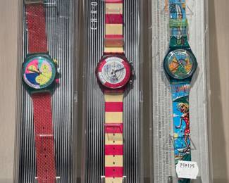 (left to right) ($100; Chrono Swatch neon flash arrow) ($100; Big Swell/Surf City Swatch) ($100; Chrono Swatch Navy Berry)