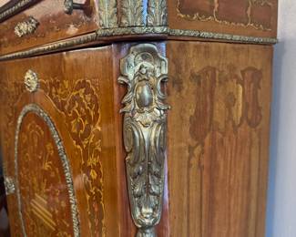 SOLD—Louis XV style Ormolu-mounted marble top cabinet with intricate wood inlay and brass details; 32x16x38; close up of brass detail