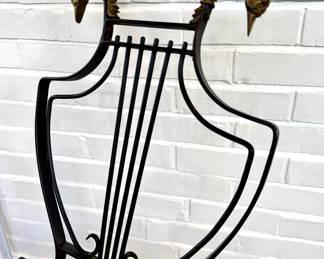STAFF FAVORITE! $1000; pair of vintage French wrought iron chairs with brass swan head finials and harp back; 21x20x34; closeup view of brass heads