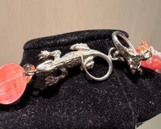 $100; Two Blond Lizards beaded, double stranded necklace with floral accent and lizard clasp; close up of lizard clasp