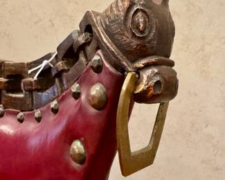 SOLD--(1 red, 1 navy available); vintage leather bar stool with wood carved horse heads and brass bits; 19x16x40; close up view of horse heads and brass bits