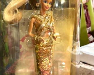 Two tables full of collector Barbies and Madame Alexander dolls. Visit the sale in person to see entire collection.