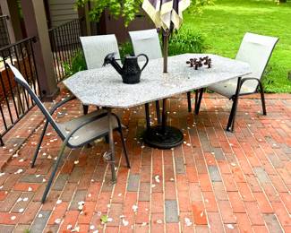 ($550; custom granite outdoor table with metal base and climbing frog detail on one leg; 73x30x38) ($20 each-4 available; outdoor dining chair)