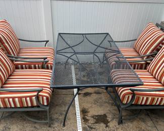 Set of four cushioned chairs; black wrought iron table