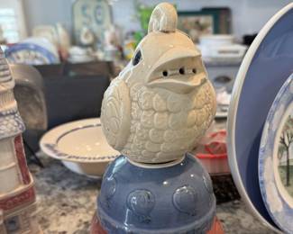 Parmesan Cheese Bird perched on 2 country ceramic bowls