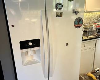 Whirlpool Side-by-Side Refrigerator with Ice/Water	White Whirlpool refrigerator/freezer with side-by-side doors and in-door dispenser. Clean and functional.
