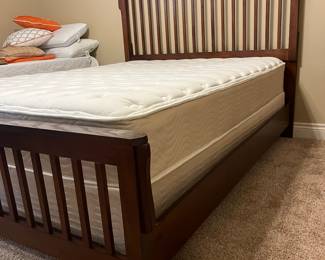 Queen wooden bed.