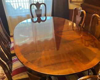 Cherry dining table set with two leaves and six chairs.