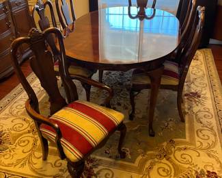 Cherry dining table set with two leaves and six chairs.