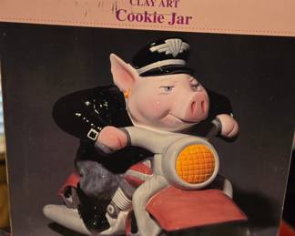 Ceramic pig riding a motorcycle cookie jar