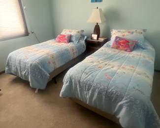Twin beds with metal bed frames.