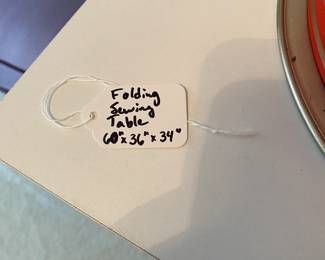 R102 - $100. Folding Sewing Table. Measures 60" x 36" 34" tall.