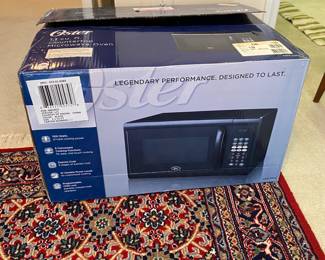 R103 - $40. Oster 1.1 Cu Ft. Counter Top Microwave. Black. New in Box.