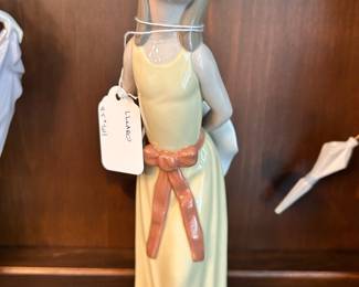 R140 - $15. Lladro "Girl with a Yellow Dress". Measures 9.5" tall.