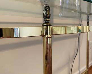 R27 - $200. Vintage Ethan Allen Brass Console Table with glass table. Measures 53.5" wide x 16" deep x 28" tall.