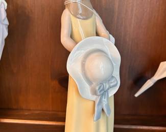 R140 - $15. Lladro "Girl with a Yellow Dress". Measures 9.5" tall.