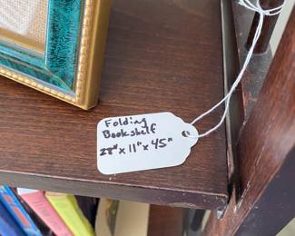 R98 - $60. Folding Wood Bookshelf. Measures 28" wide x 11" deep x 45" tall.