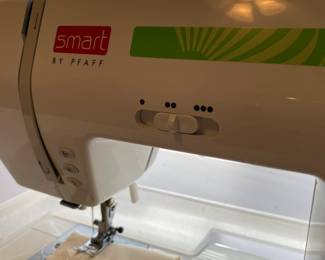 R99 - $225. Sewing Machine & Table. Smart by Pfaff. Model 200c. Table measures 40" long x 20" deep x 39" tall.