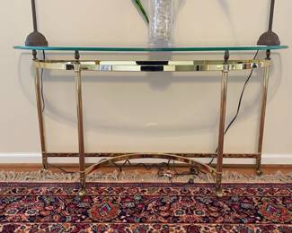R27 - $200. Vintage Ethan Allen Brass Console Table with glass table. Measures 53.5" wide x 16" deep x 28" tall.