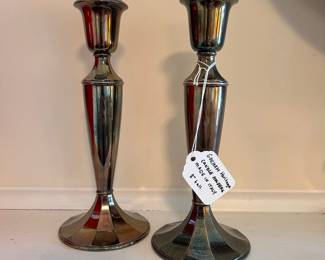 R134 - $10. Silver plated candle holders. Measures 8" tall.