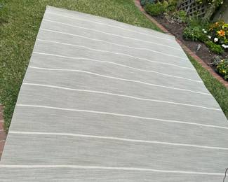 There are two of these one still wrapped 8x10 Dove grey and cream wool rugs