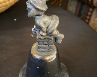 vintage silver plated christmas bell with pewter santa claus figurine on top of chimney 